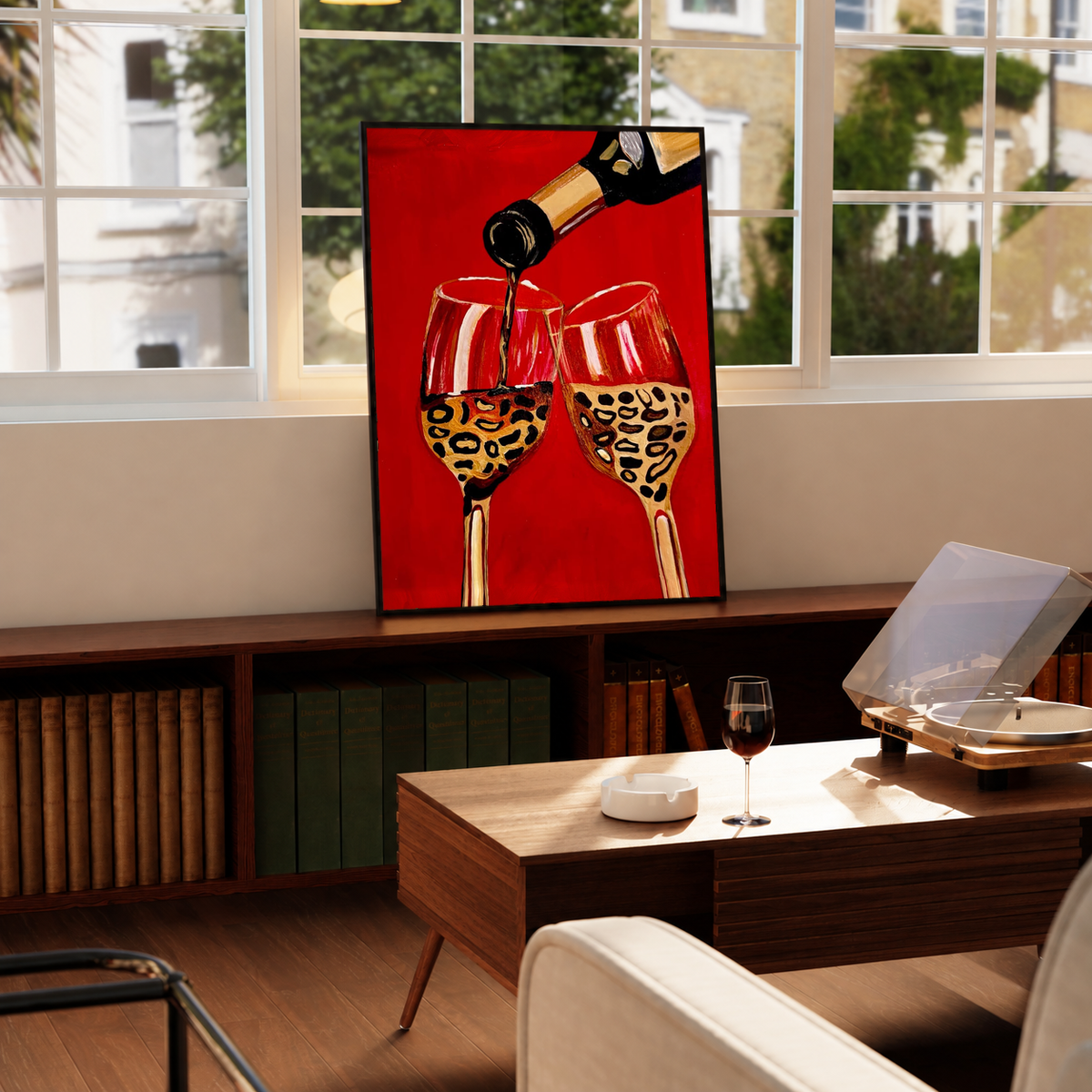 Framed poster with wine bottle pouring into two leopard-pattern wine glasses on red