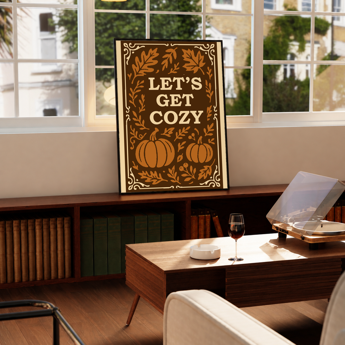 Framed autumn poster with cream border, brown leaves, pumpkins, and “Let’s Get Cozy” text