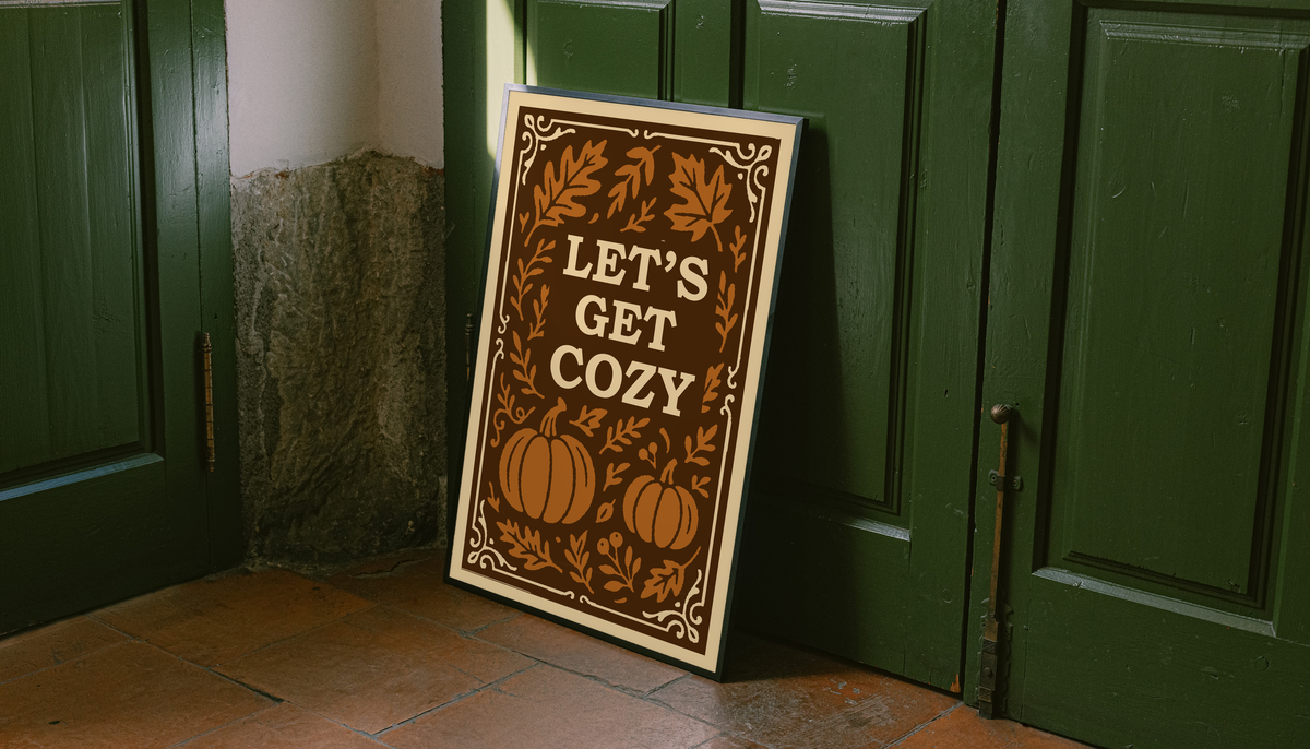 Standing framed autumn poster with cream border, brown pumpkins and leaves, “Let’s Get Cozy”