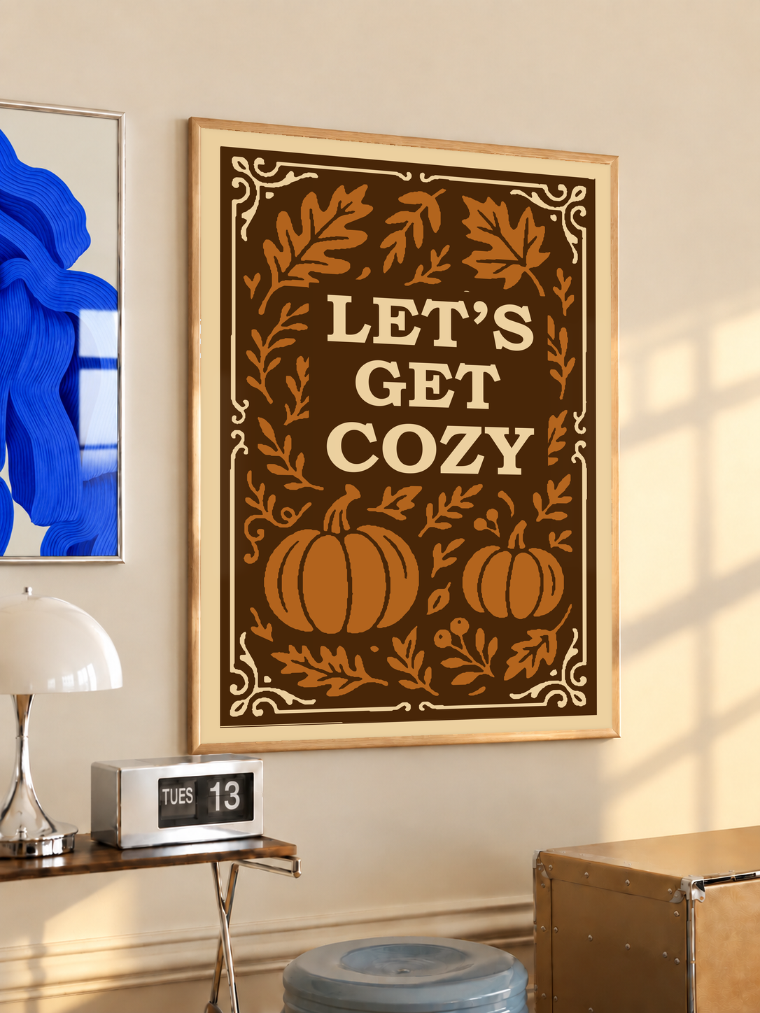 Framed autumn poster with cream border, brown pumpkins and leaves, “Let’s Get Cozy” lettering