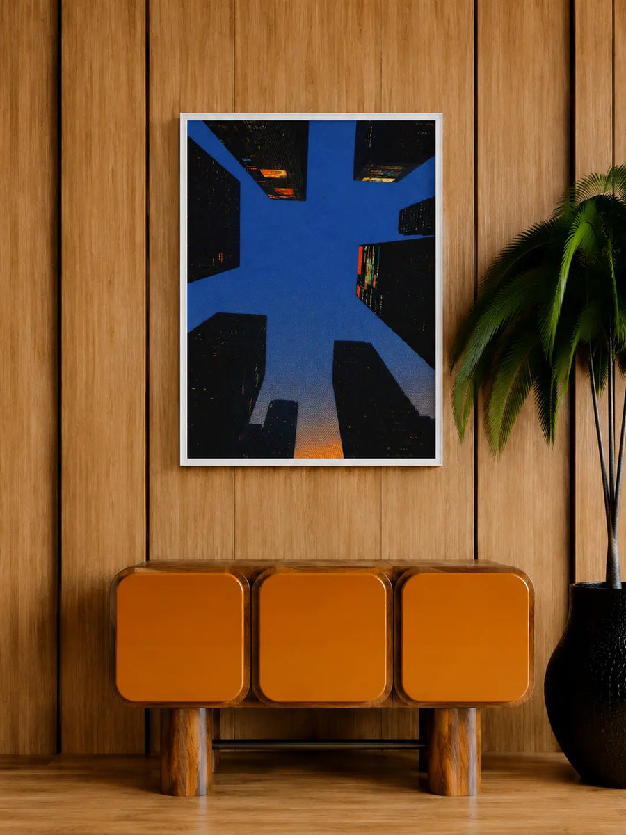 Lámina enmarcada con borde blanco para pared, con geometría urbana azul y cálidos toques de luz