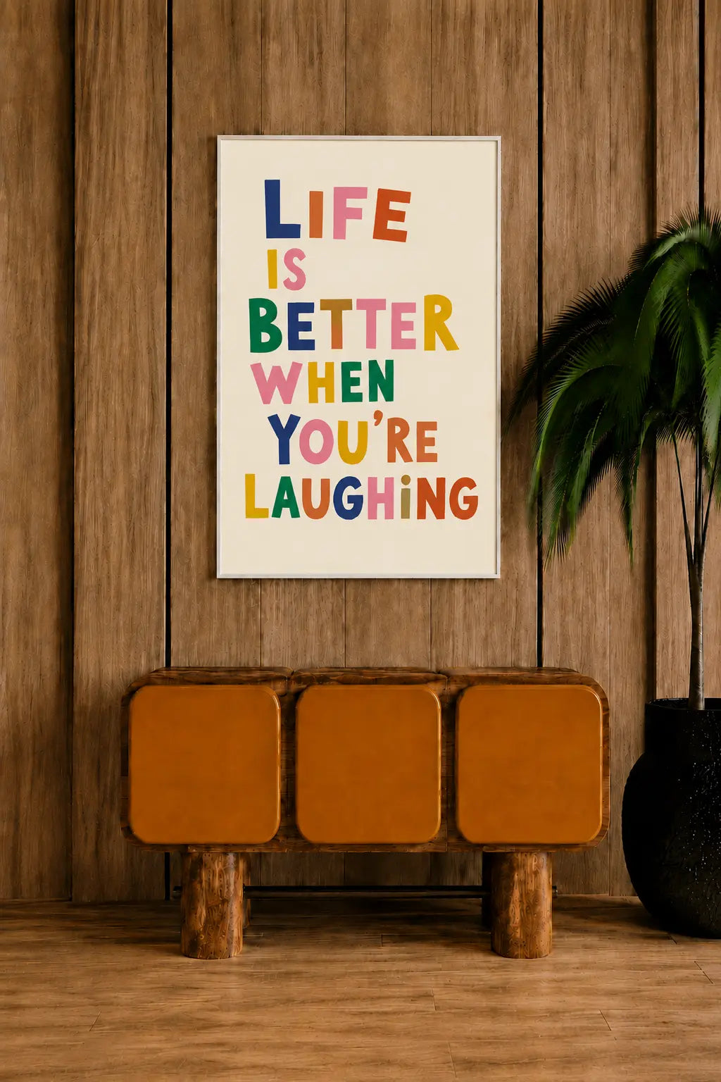 Colorful typographic framed poster with text "LIFE IS BETTER WHEN YOU'RE LAUGHING"