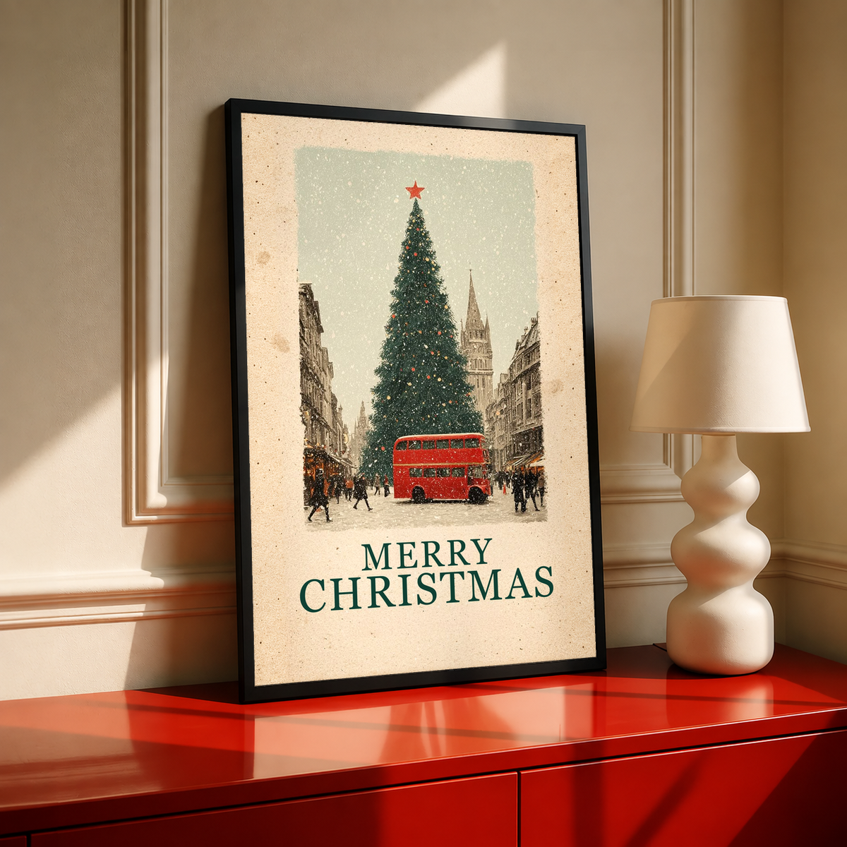 Black-framed Christmas poster showing red bus, evergreen tree, and “MERRY CHRISTMAS”