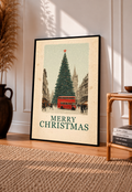 Black-framed Christmas poster with red bus, evergreen tree, and “MERRY CHRISTMAS” text