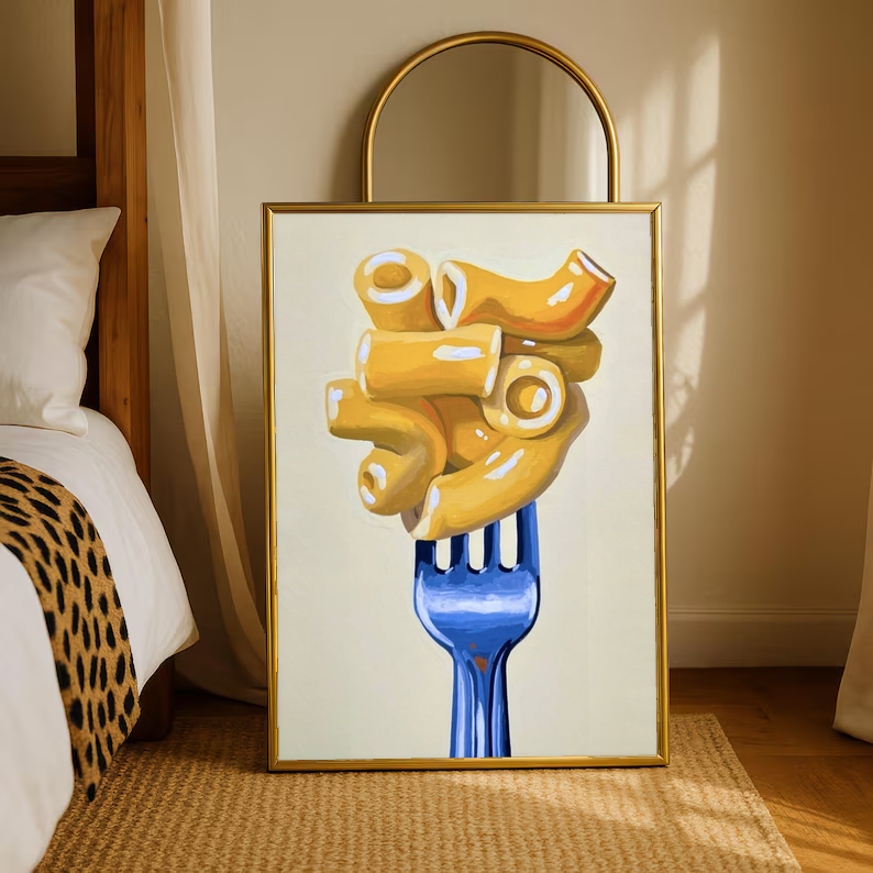 Framed wall art print of golden macaroni on a blue fork on a cream background