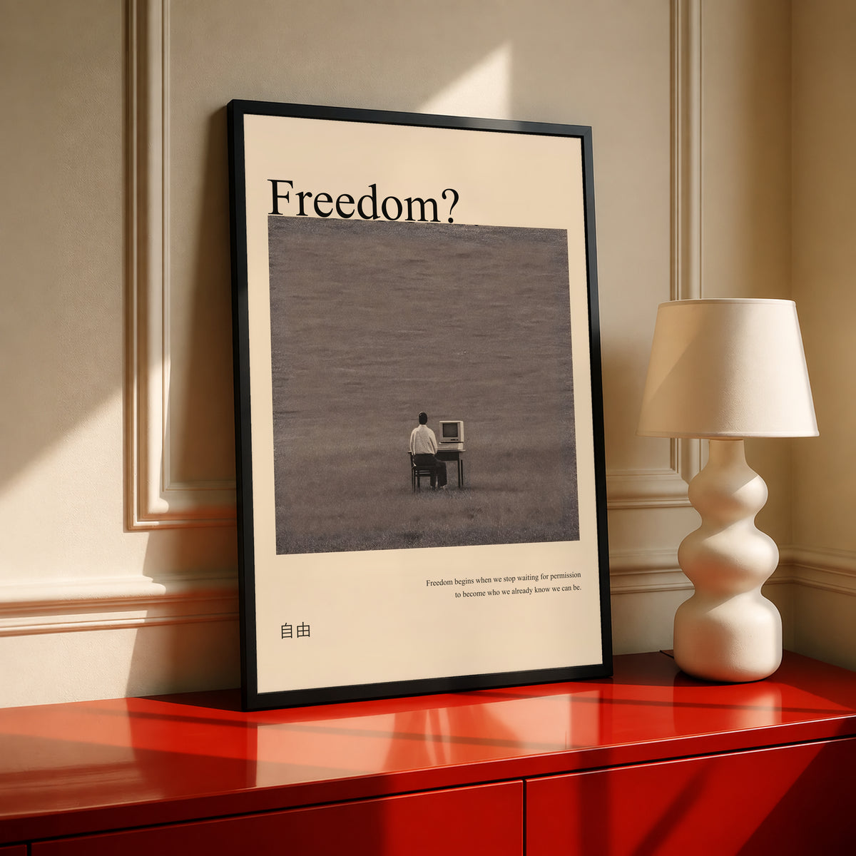 Black framed art poster with “Freedom?” title and a man at desk on gray background