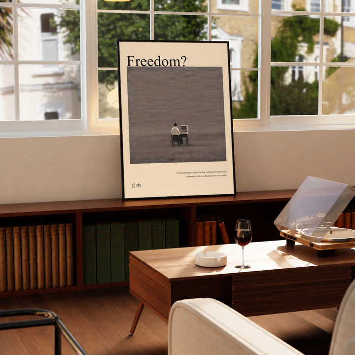 Framed art poster on a tabletop with “Freedom?” title and seated man at desk