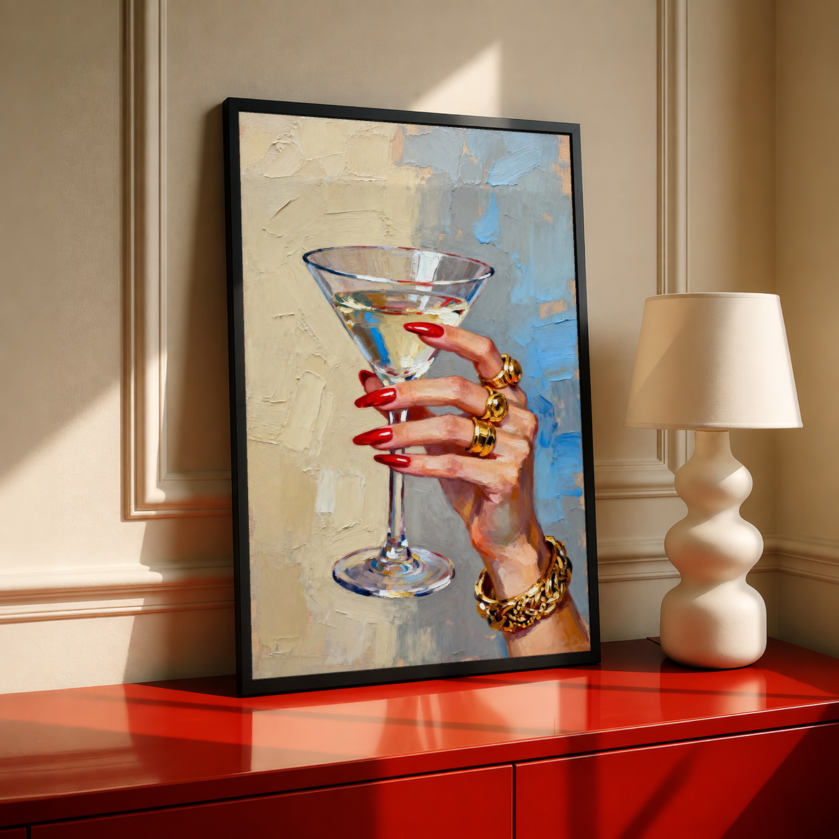Black-framed hand print artwork featuring martini glass, red nails, and gold rings