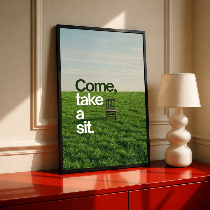 Framed landscape quote poster with green field, chair, and "Come, take a sit."