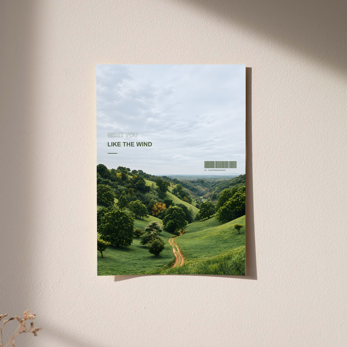 Green valley and winding path beneath Meet You Like the Wind lettering; unframed print on a wall