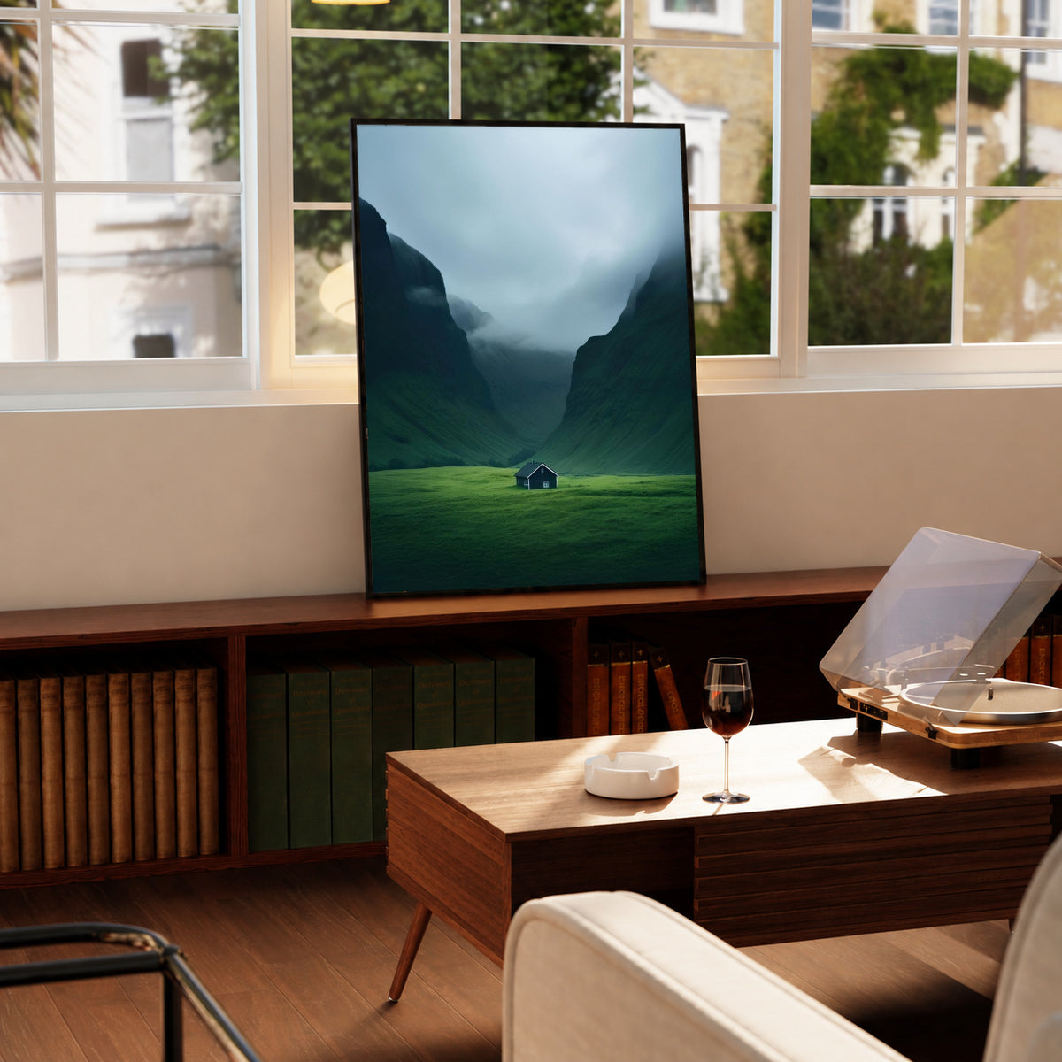 Black-framed mountain valley print with misty blue mountains and small green cabin