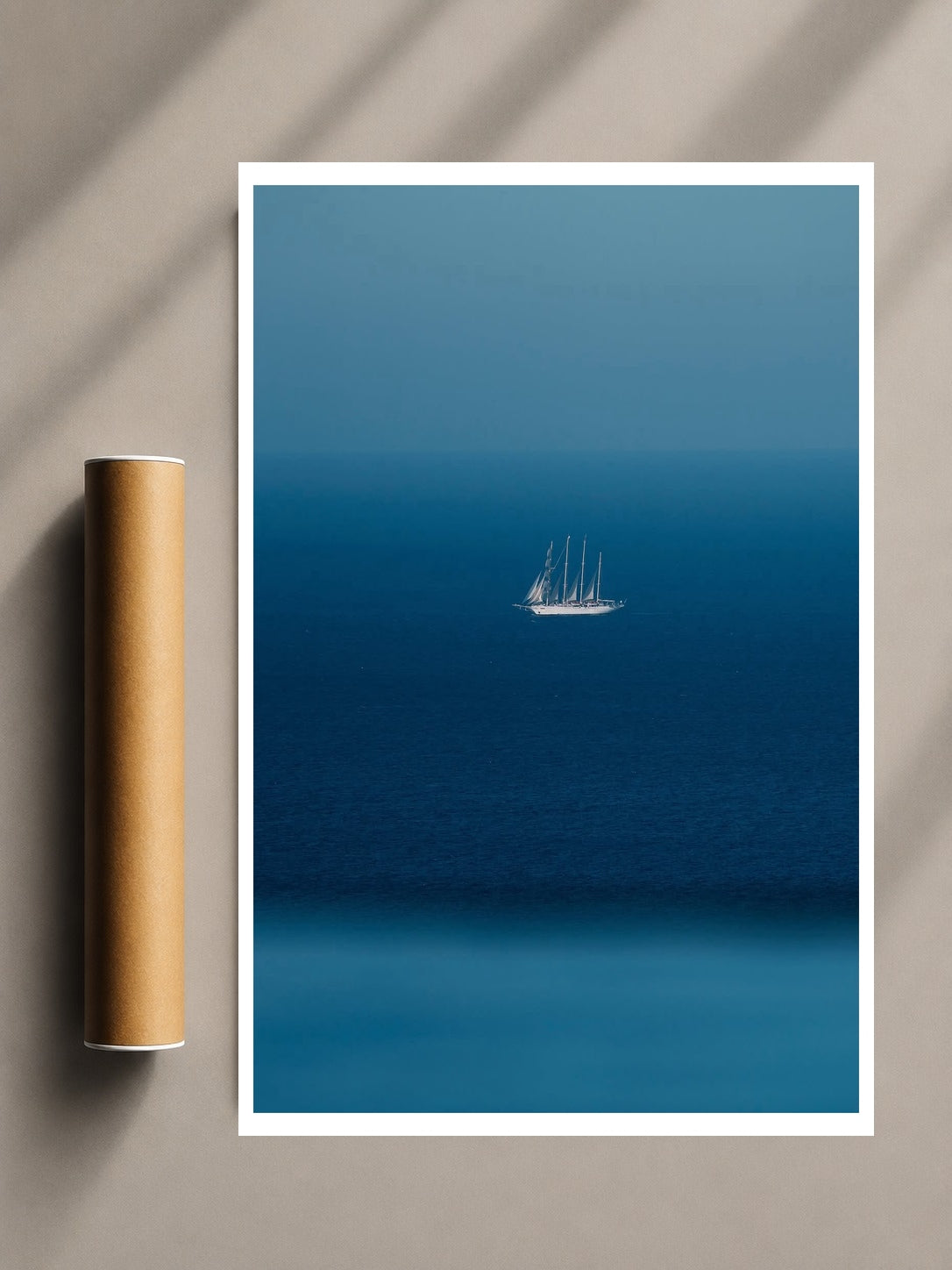 Minimalist Sailboat Print with a lone white sailboat floating across a deep blue sea beneath a clear horizon.