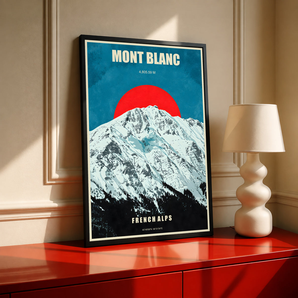 Mont Blanc poster in a black frame, featuring snowy Alps and a red sun