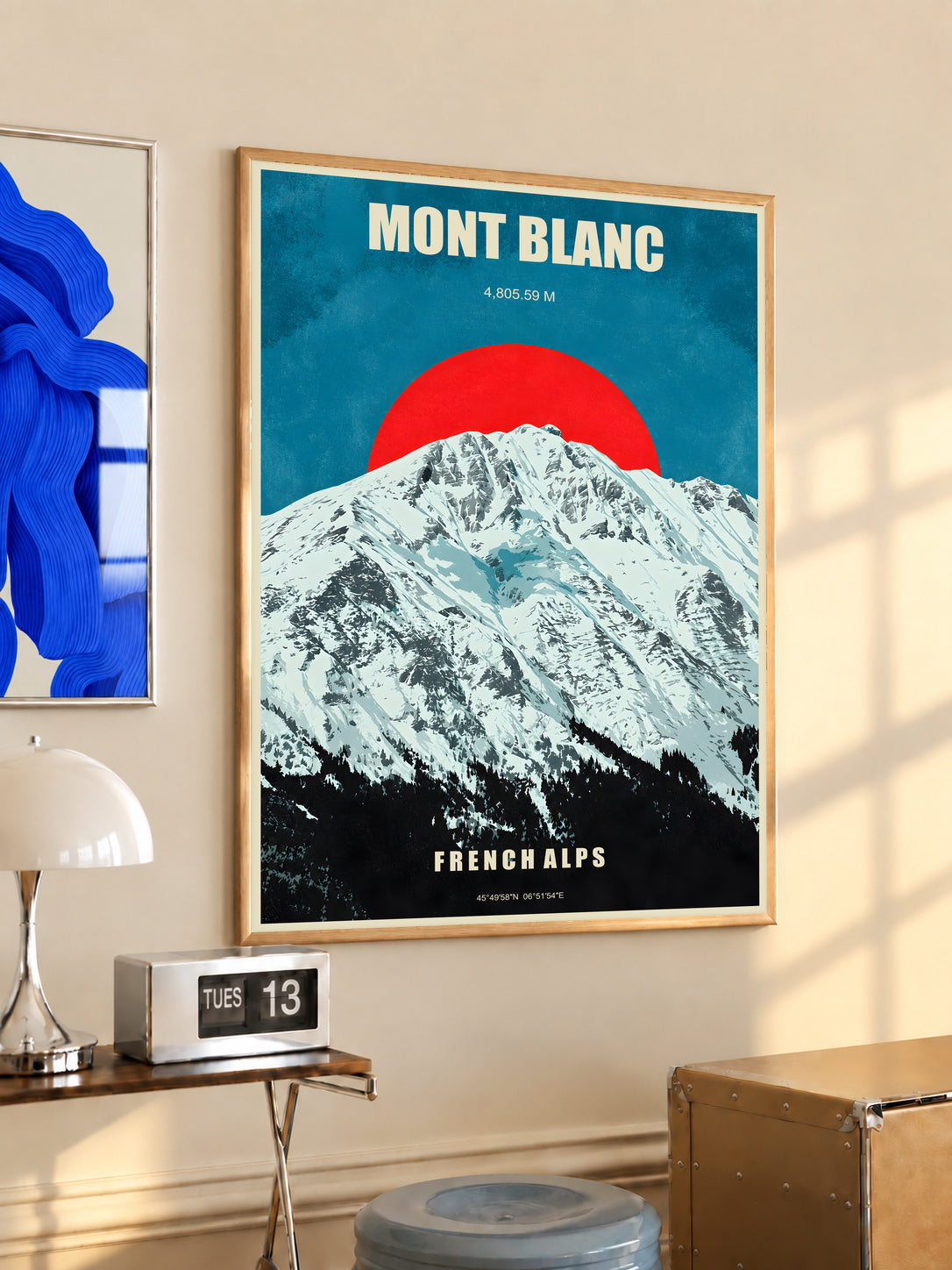 Mont Blanc poster in a light wood frame with snowy Alps and red sun