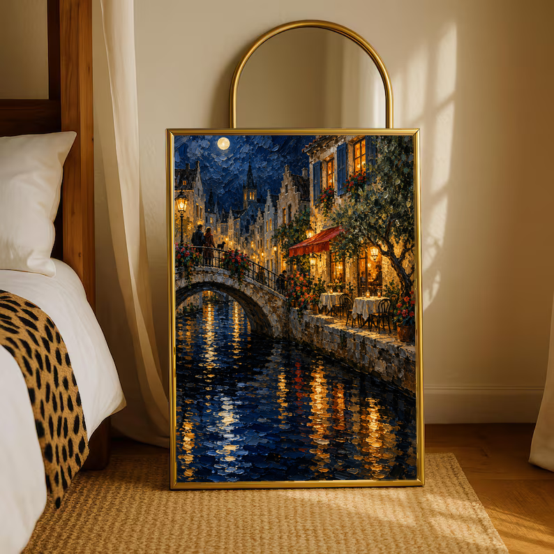 Gold-framed wall art print of moonlit canal bridge with glowing windows and water reflections