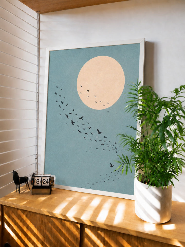 Framed minimalist bird wall art with pale moon circle and flock of birds