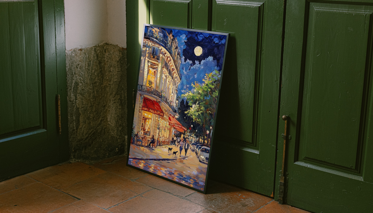 Framed French café print leaning against green doors, showing a moonlit street scene.