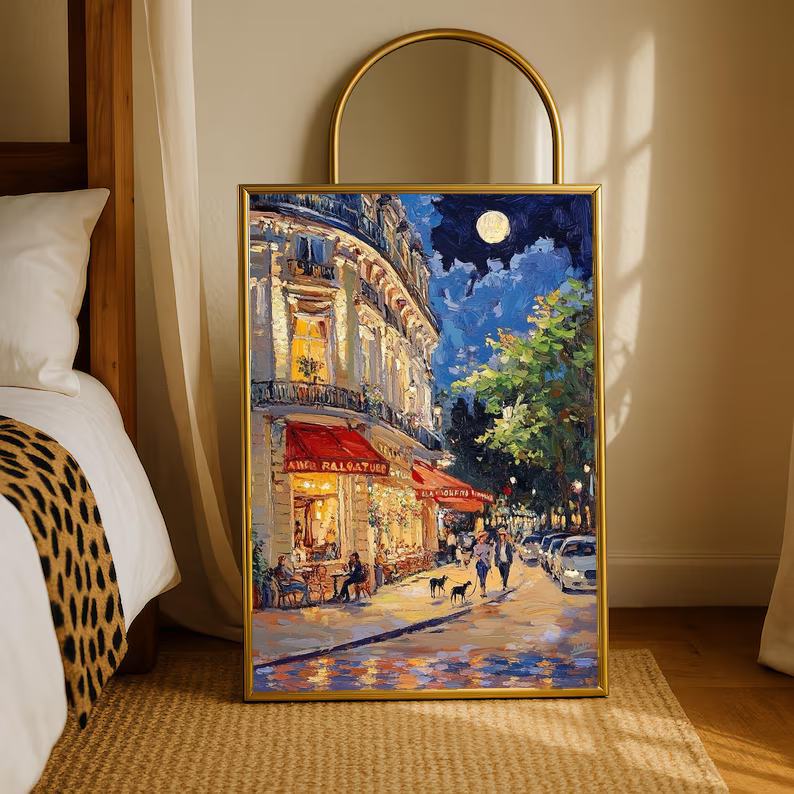 Framed art print of a moonlit French café street with red awnings and glowing corner building