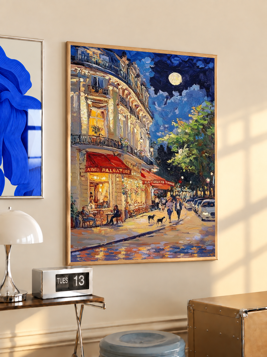 Oak-framed art print of a moonlit French café street scene with red awnings