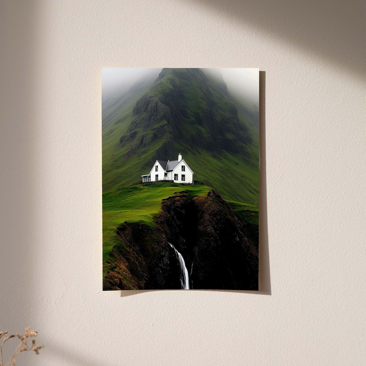 White cottage, misty mountain and waterfall as an unframed print against a pale plaster wall with soft shadows