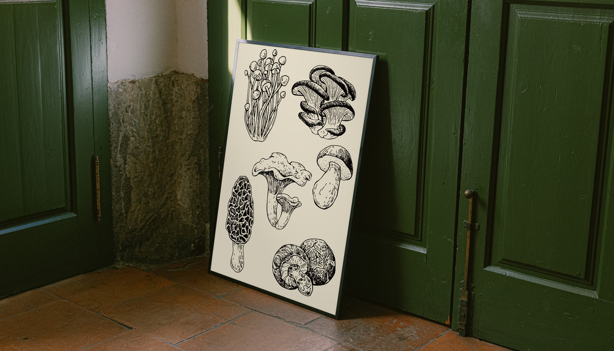 Six mushroom specimen studies with varied caps stems and gills in black ink style as an unframed print leaning against a green panelled door