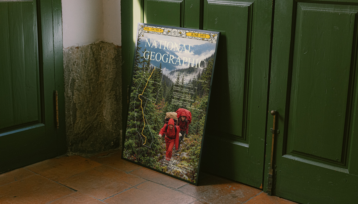 Red-jacketed hikers in a green forest with yellow route map and magazine-style heading; unframed canvas styled by a green doorway