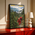 Red-jacketed hikers in a green forest with yellow route map and magazine-style heading; black framed print on a red cabinet