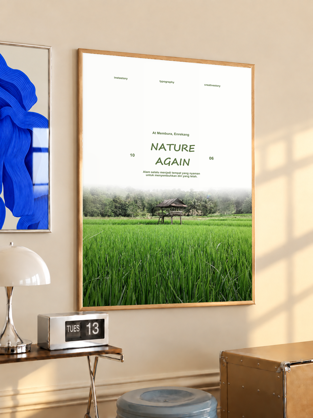 Green rice field and small wooden pavilion beneath Nature Again lettering; oak framed print in a desk setting