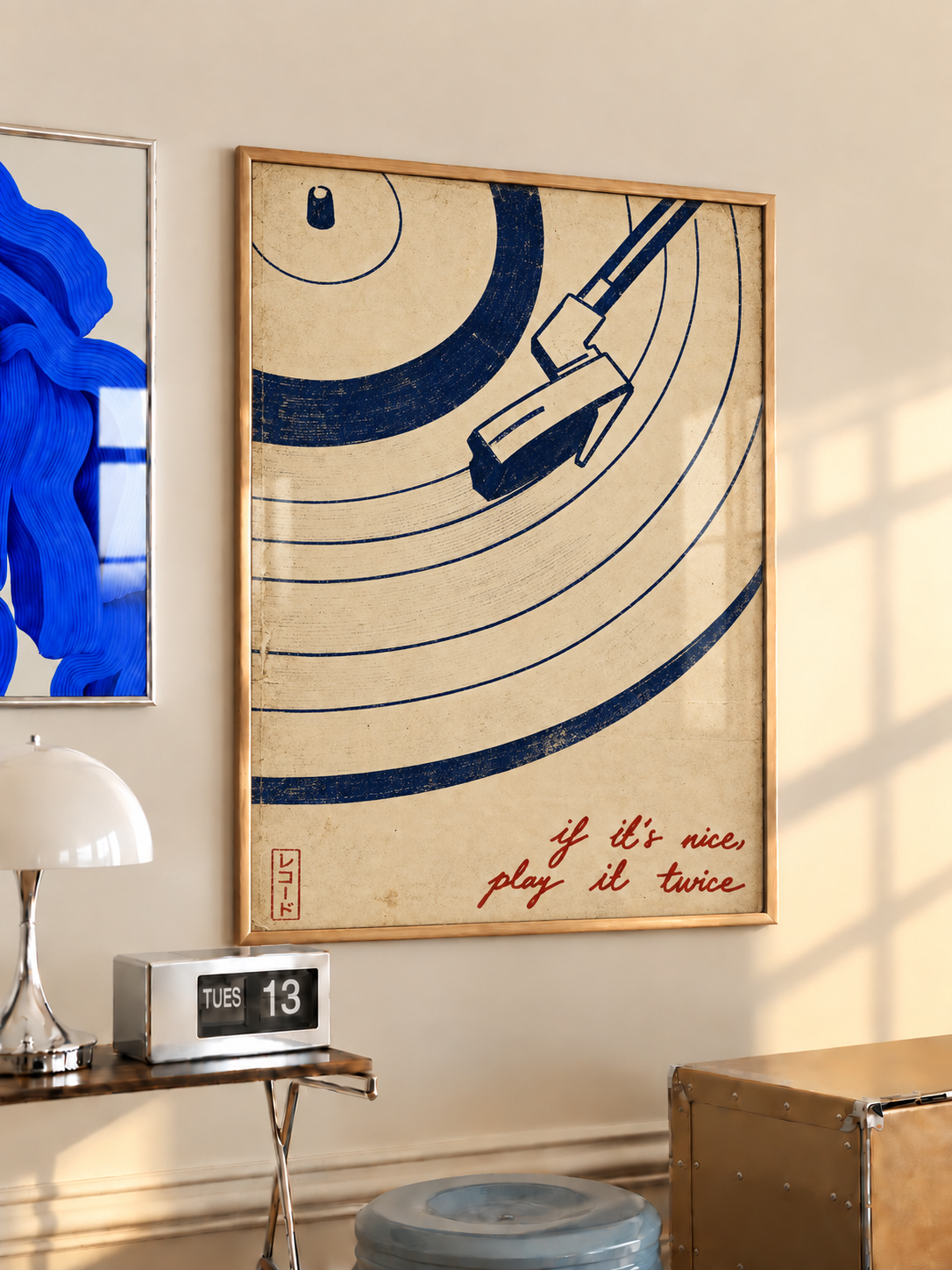 Vinyl record, tonearm and play-it-twice quote wall art displayed in styled interior view 2