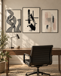 Set of three framed abstract wall art prints in black and beige on black frames
