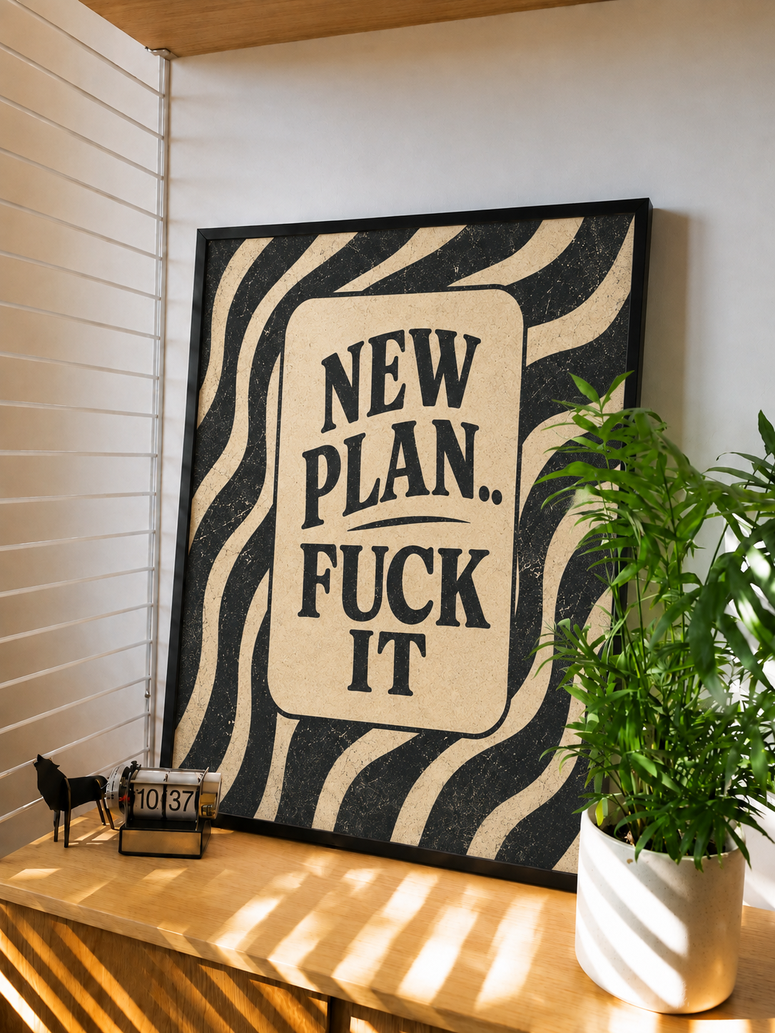 Framed typography wall art with black text on cream label, zebra stripes, black frame