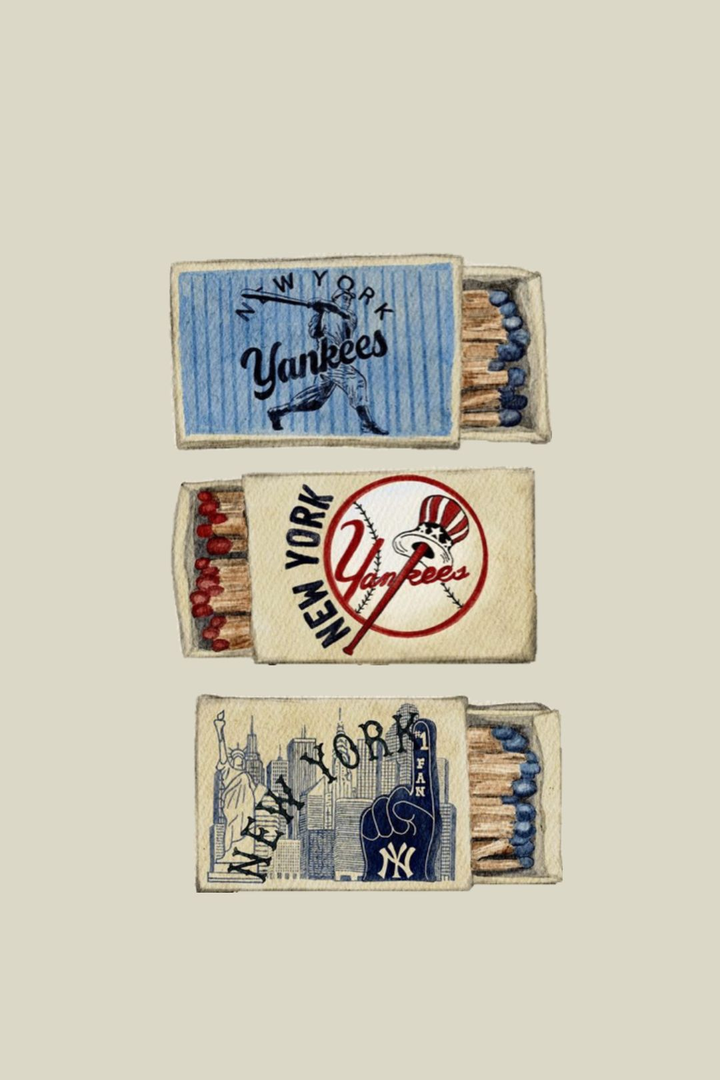 Three illustrated open matchboxes show New York baseball motifs, Yankees lettering, skyline and foam finger. Printed text: New York; Yankees; #1 FAN.