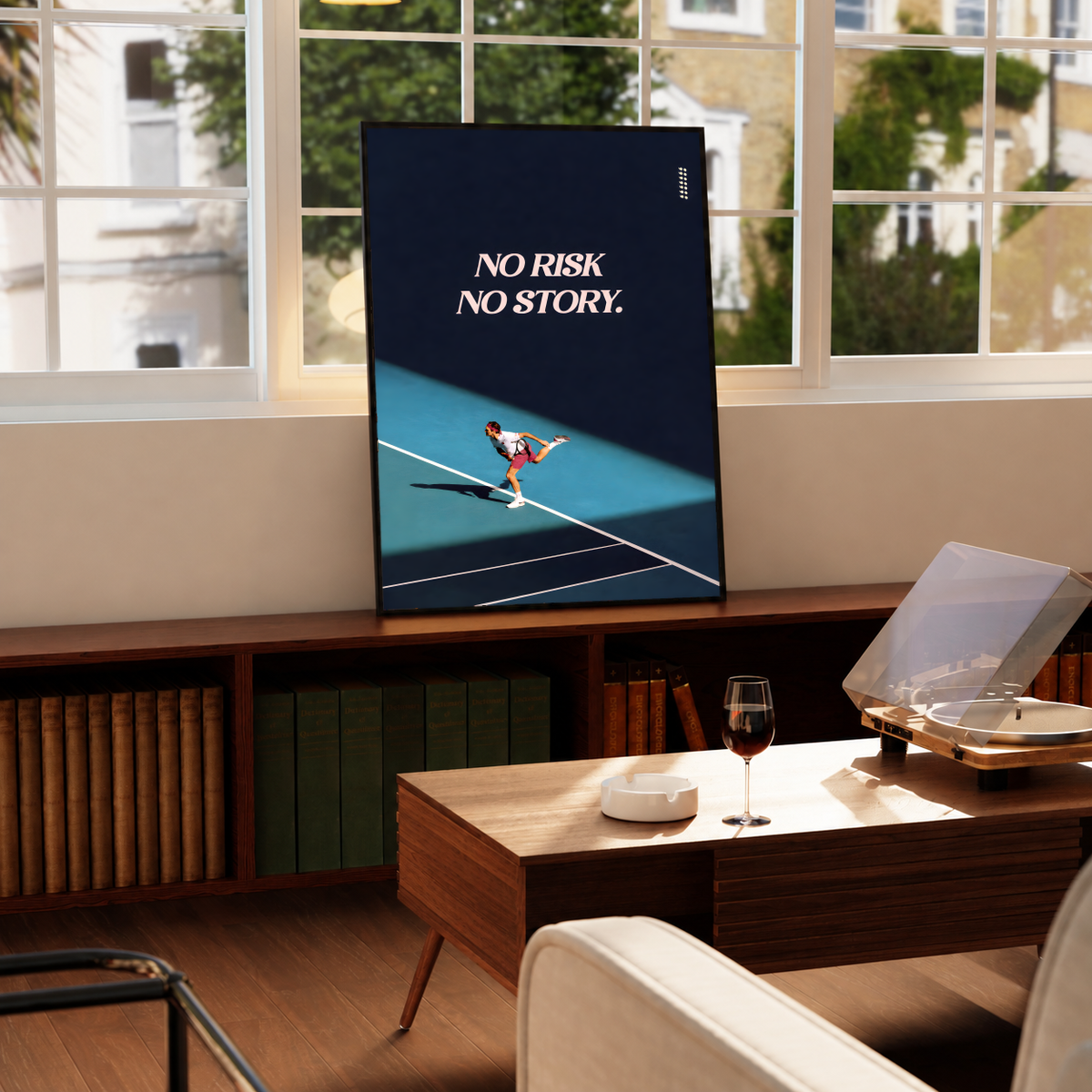 No Risk No Story quote in pale pink above a tennis player on a turquoise court with a diagonal shadow, styled in a black frame above a wood console with books and a record player