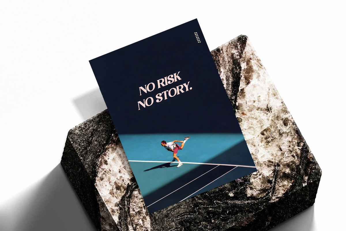 No Risk No Story quote in pale pink above a tennis player on a turquoise court with a diagonal shadow, shown as an unframed print tilted on a dark stone display against a light background