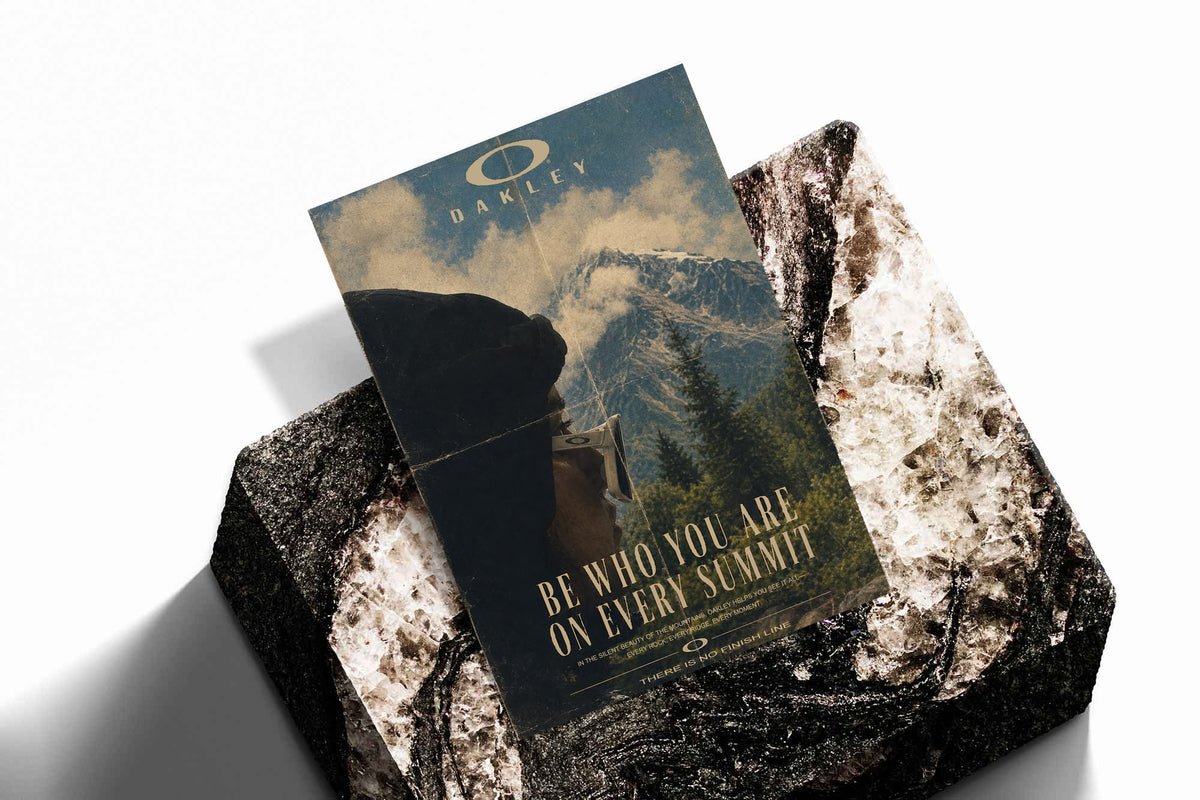 Blue mountain poster print with Oakley logo and gold message, angled view