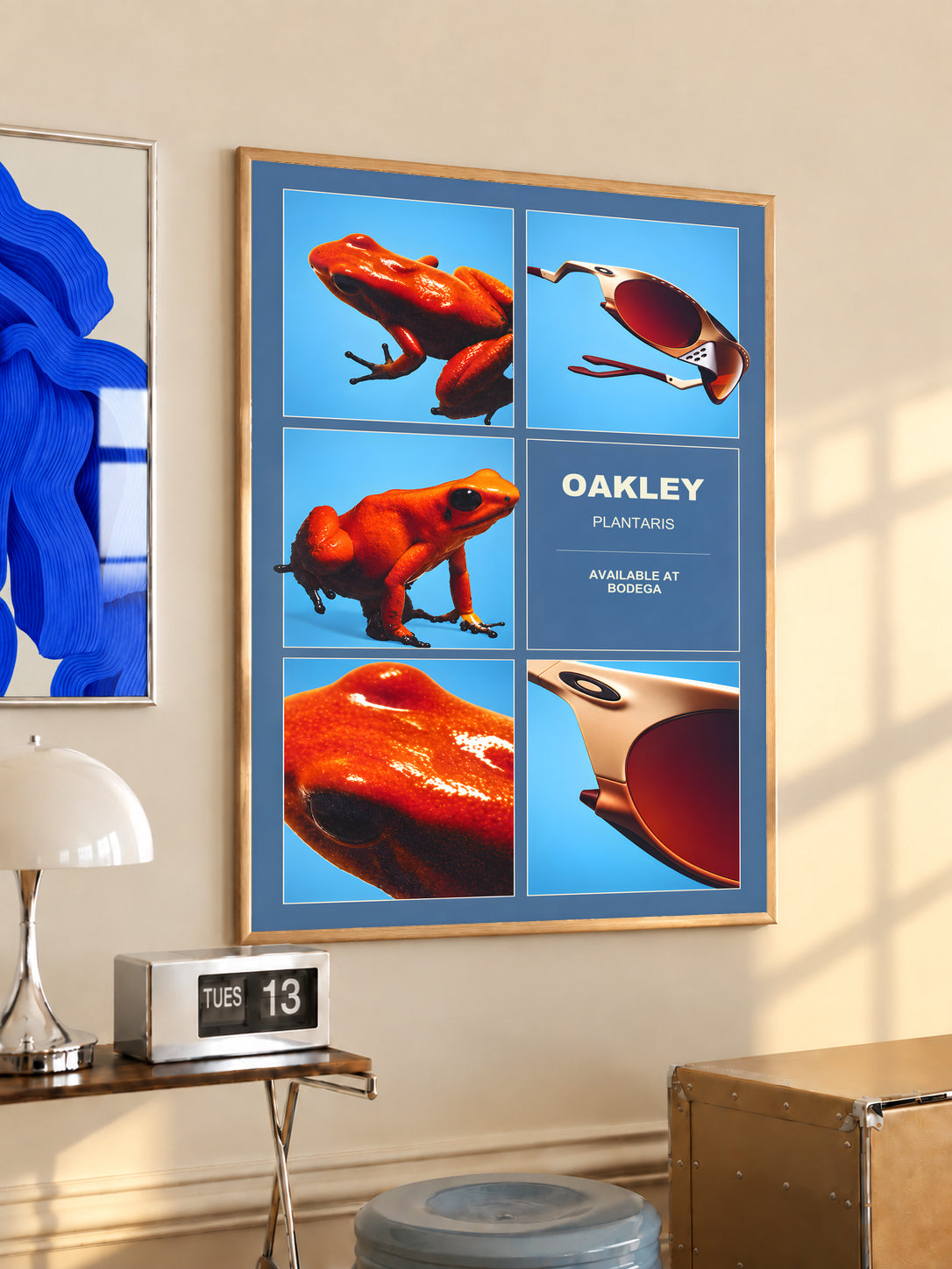 Oakley Plantaris poster in a light wood frame, with orange frogs and sunglasses.