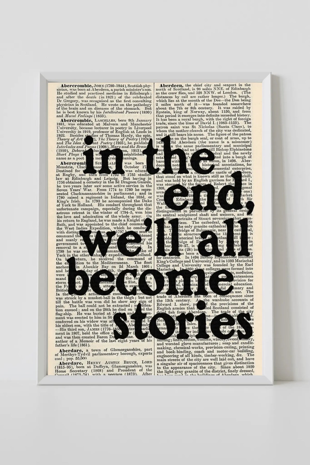 White-framed typographic print with quote in the end, we'll all become stories
