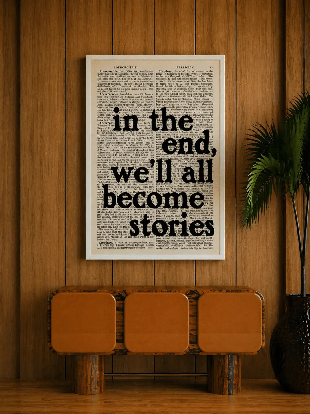 Oak-framed typographic print with quote in the end, we'll all become stories