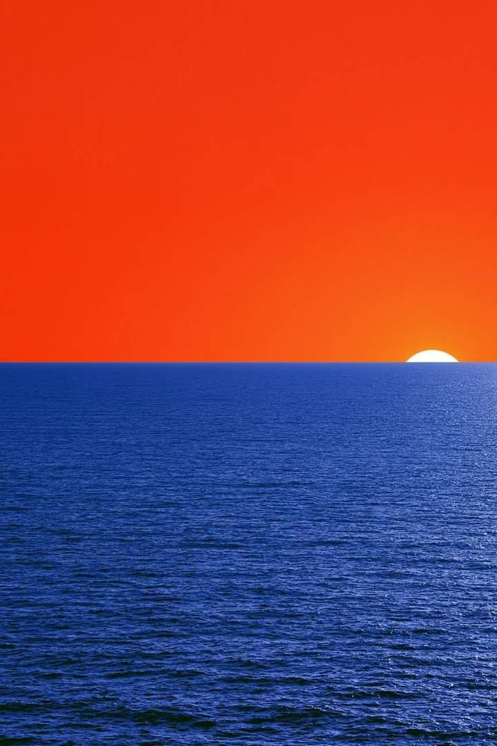 Orange and blue ocean sunset landscape print with bright orange sky and blue sea