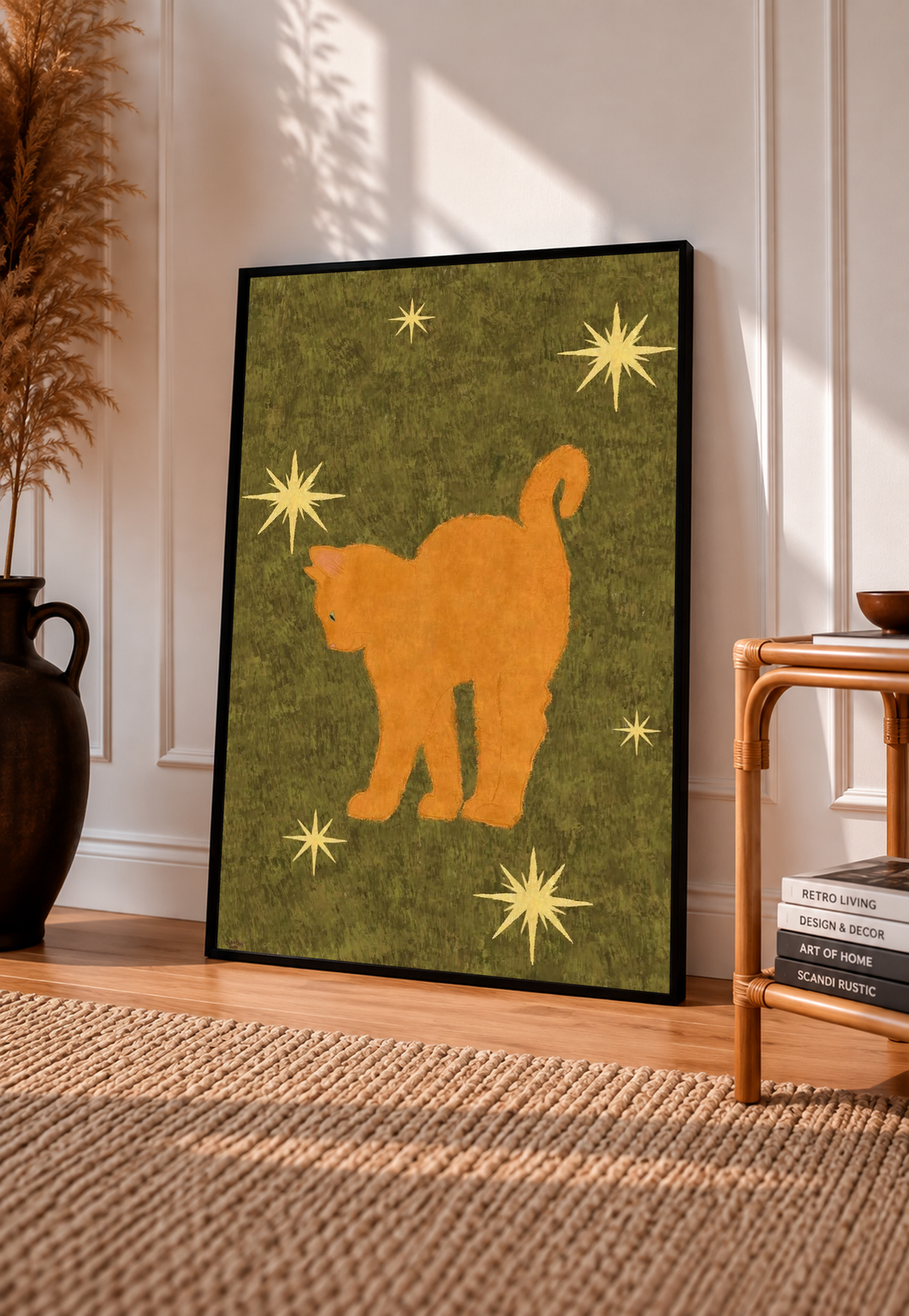 Orange cat and stars art print on an olive green background, in a black frame