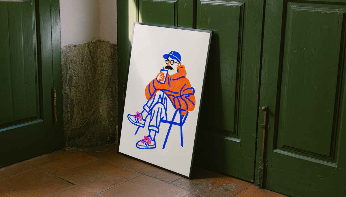 Coffee art print with light border, seated orange figure holding a cup, blue linework