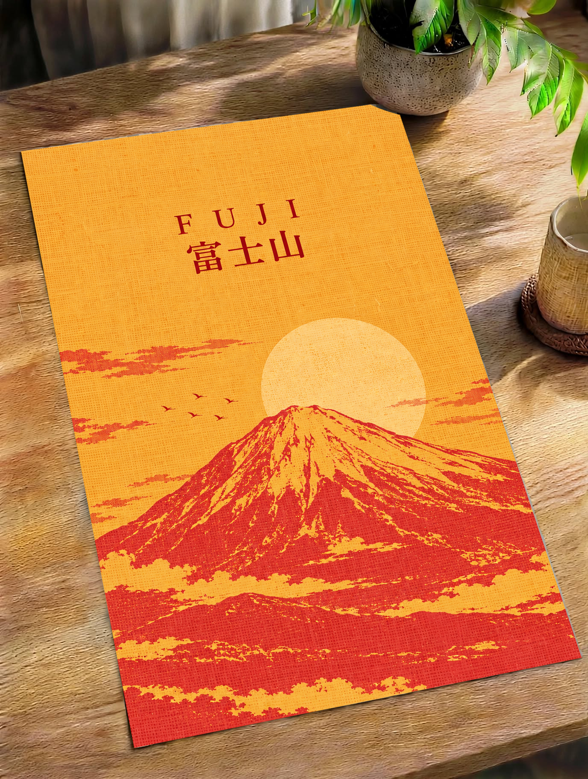 Mount Fuji sunrise poster with orange sky, red landscape, and “FUJI” title.