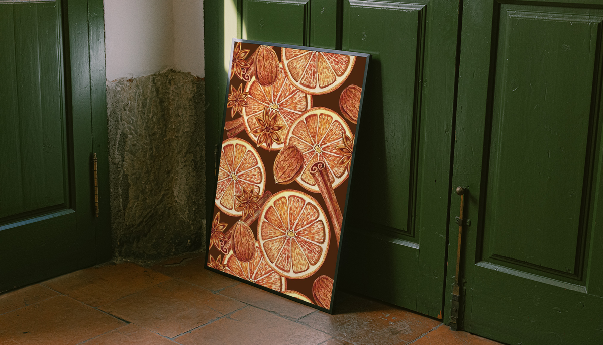 Orange slice spice art print in black frame leaning by green doors