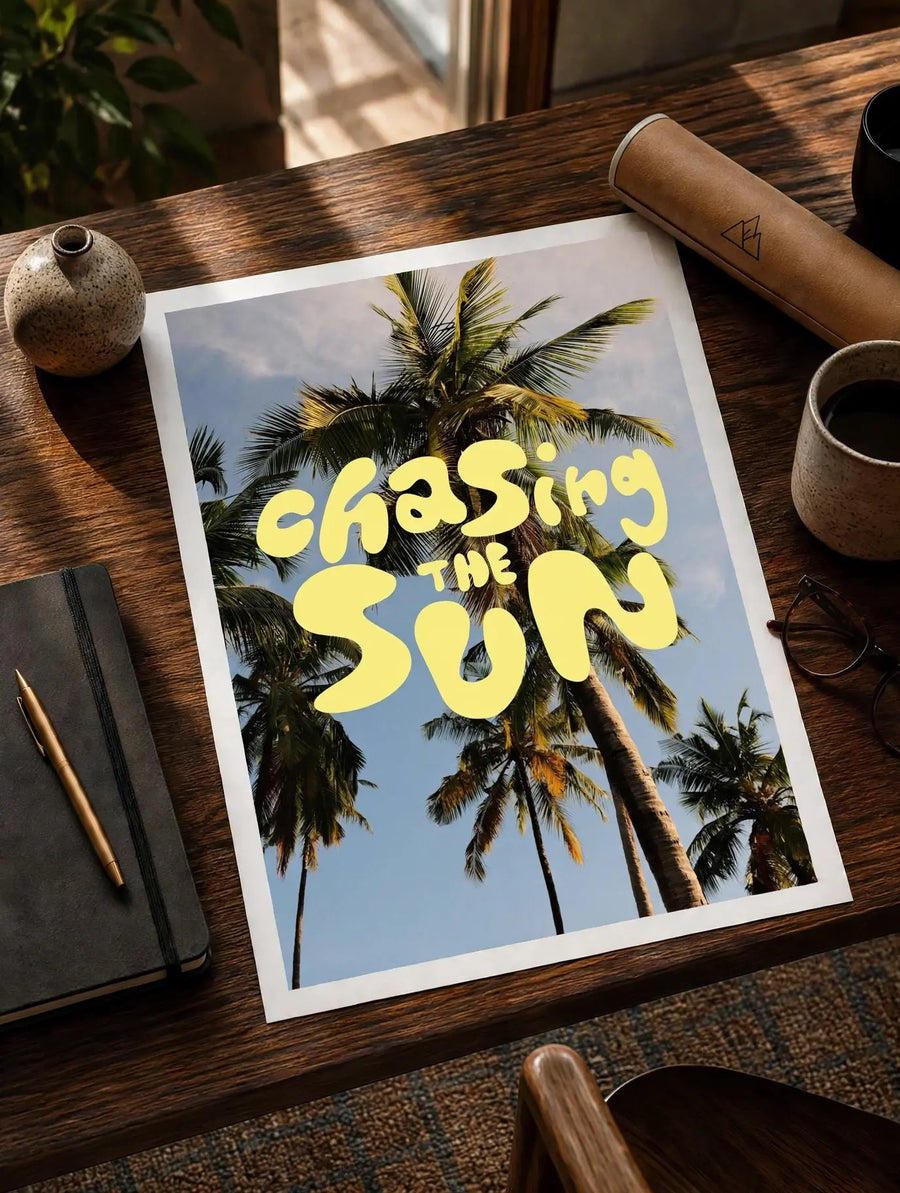 White-bordered typography print with yellow 'Chasing the Sun' and palm trees
