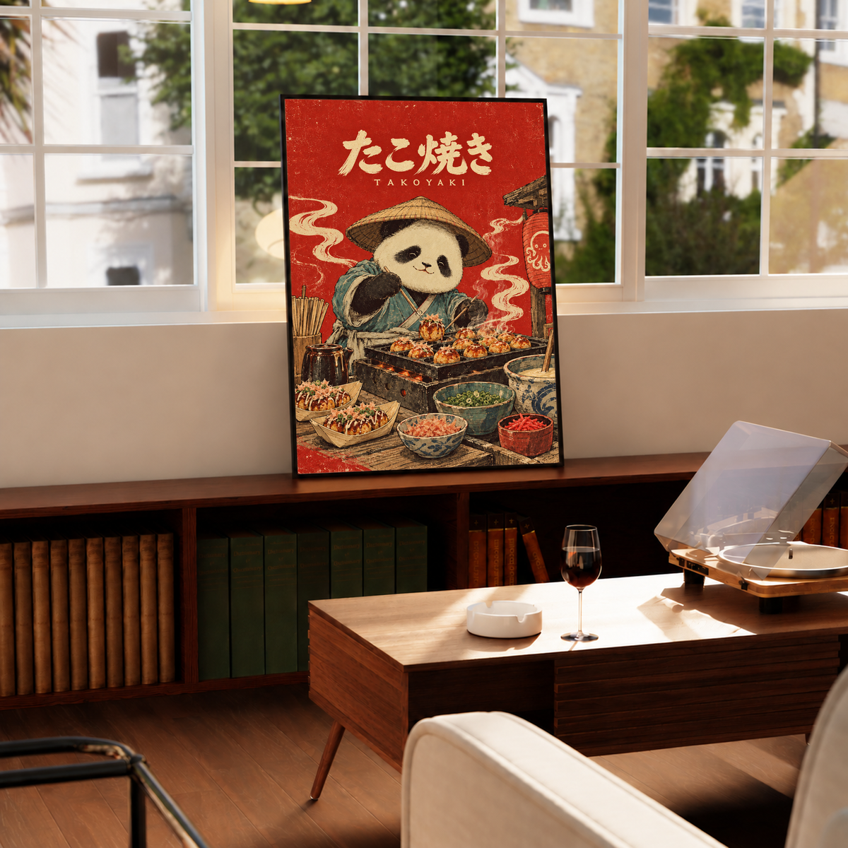 Red framed panda chef takoyaki poster displayed on countertop