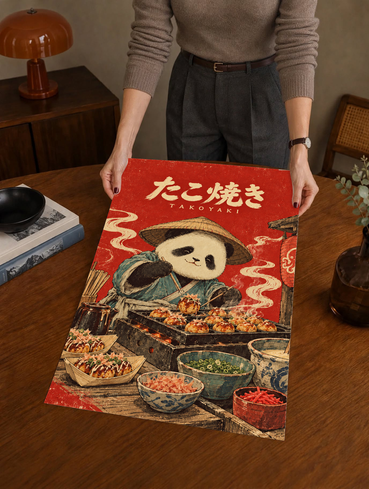 Red panda chef takoyaki poster held upright by person, framed
