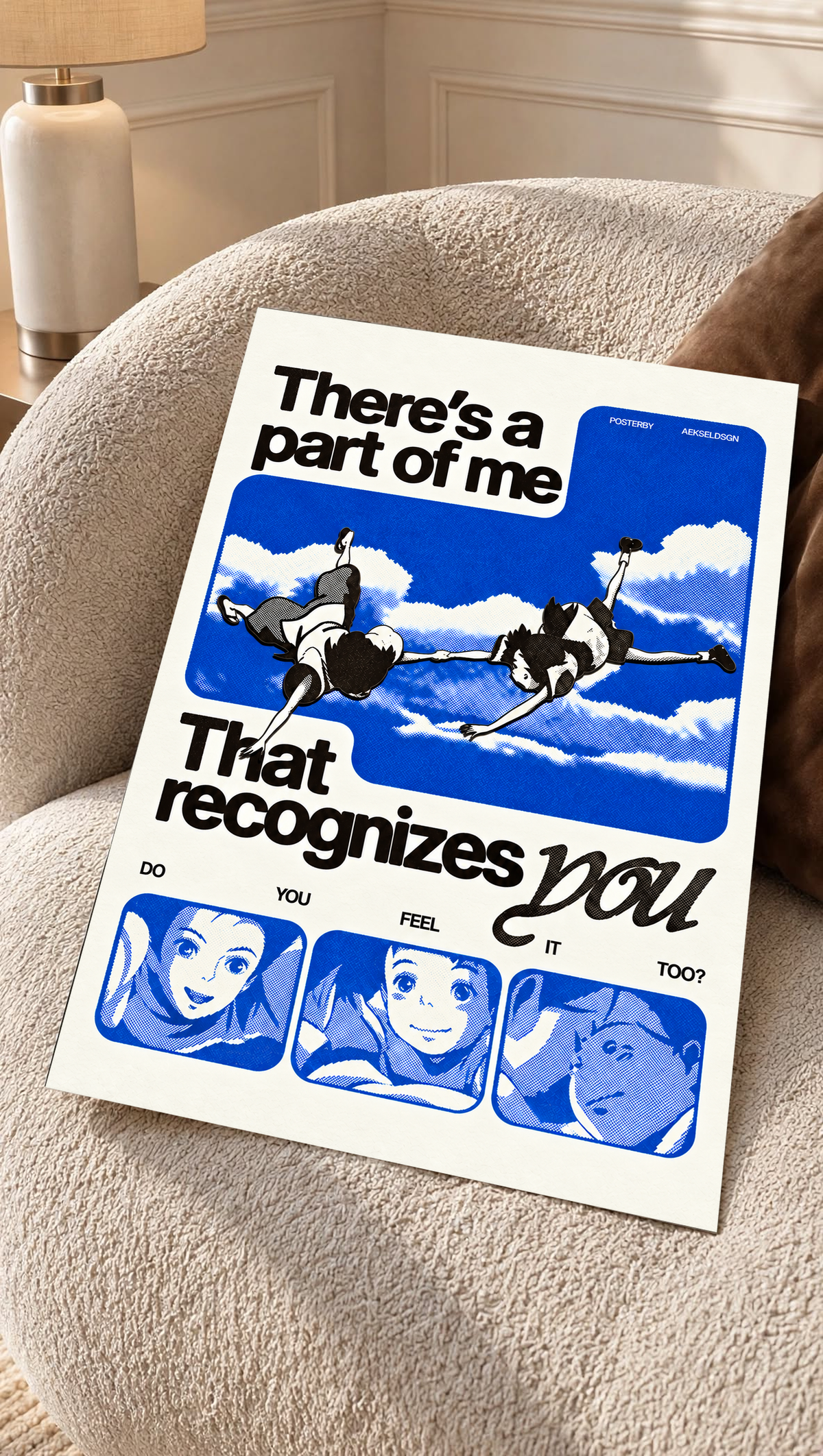 Two anime figures against blue sky with character portraits and a romantic recognition quote as an unframed poster resting on a cream woven chair
