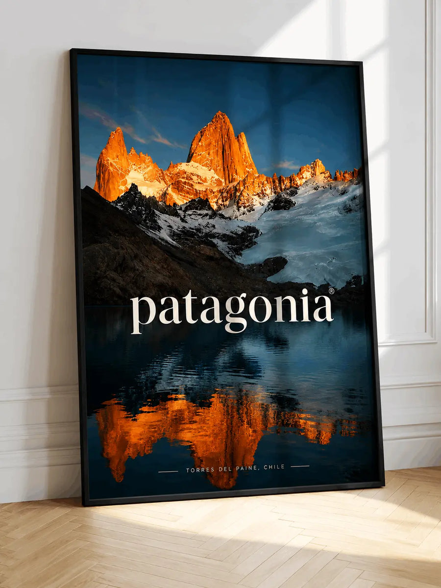 Mountain wall art poster with black frame, orange peaks and blue lake, patagonia text