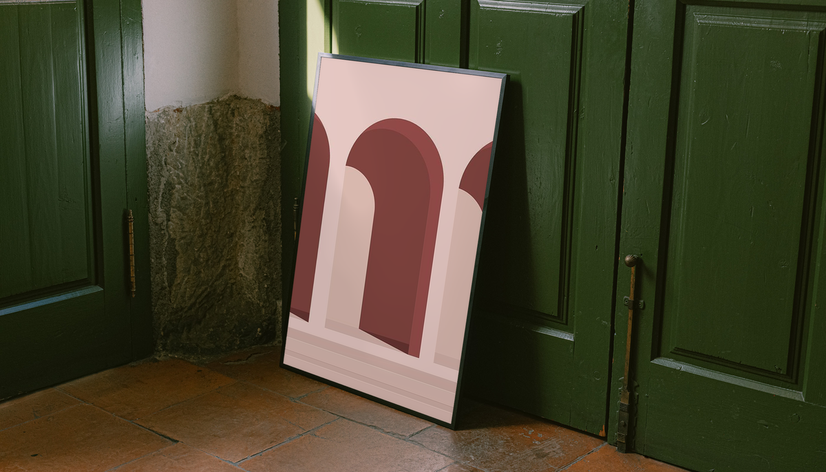 Pink Arches Wall Art shown as a canvas leaning beside green panels on a wooden floor.