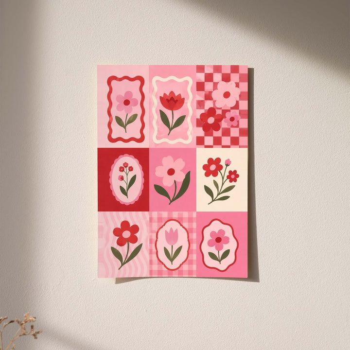 A pink and red patchwork grid of tulips, daisies, scalloped frames and checkerboard squares displayed without a visible frame on a softly lit pale wall